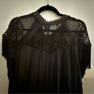 Grey dress with fun fringe details on the sleeves. Size medium